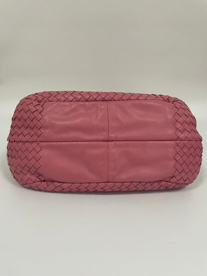 Bottom view of the Bottega Veneta Intrecciato Campana Shoulder Bag in pink woven leather, showing the structured leather base.