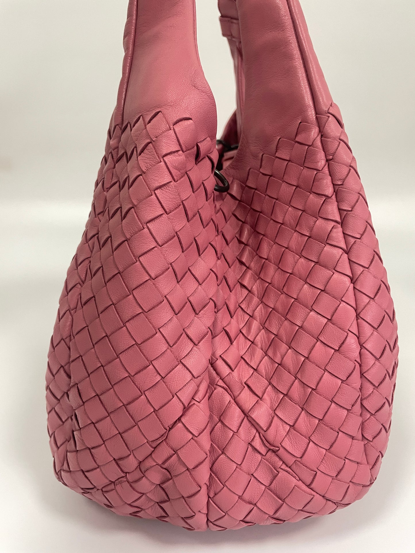 Side view of the Bottega Veneta Intrecciato Campana Shoulder Bag in pink woven leather, showing the detailed woven design and soft leather.