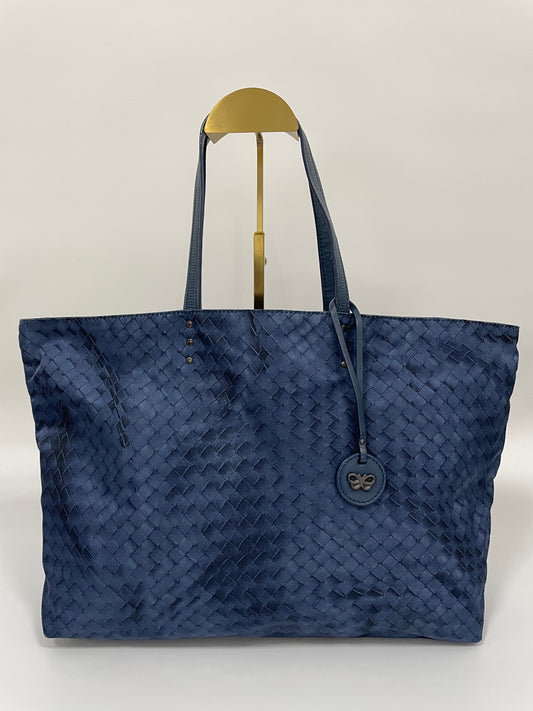 Front view of a Bottega Veneta Intrecciolusion Mirage Butterfly Tote Bag in blue, featuring a woven intrecciato design and butterfly-shaped charm.