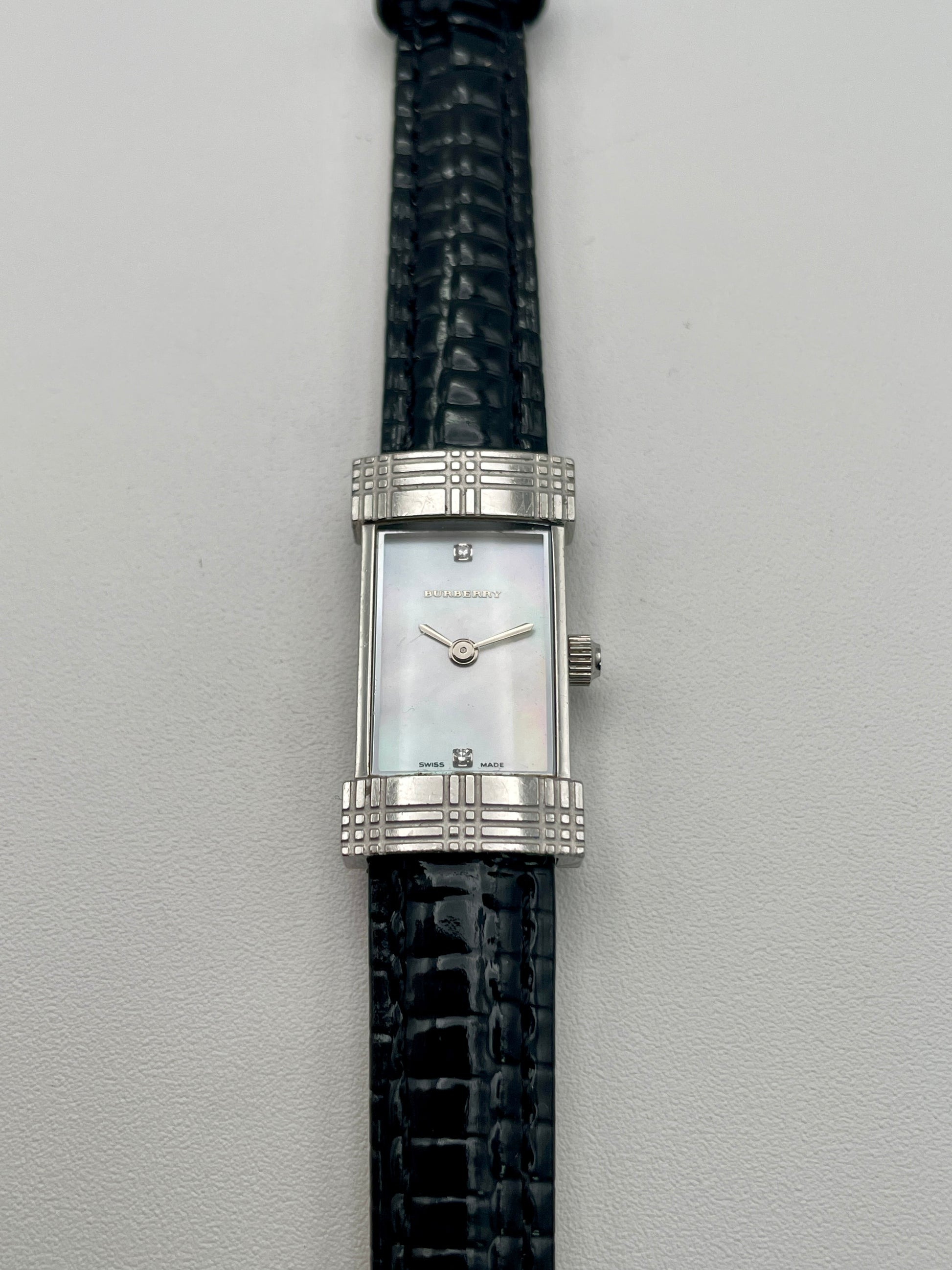 Burberry vintage women's watch with mother-of-pearl dial in a steel case and black leather strap, shown in original box
