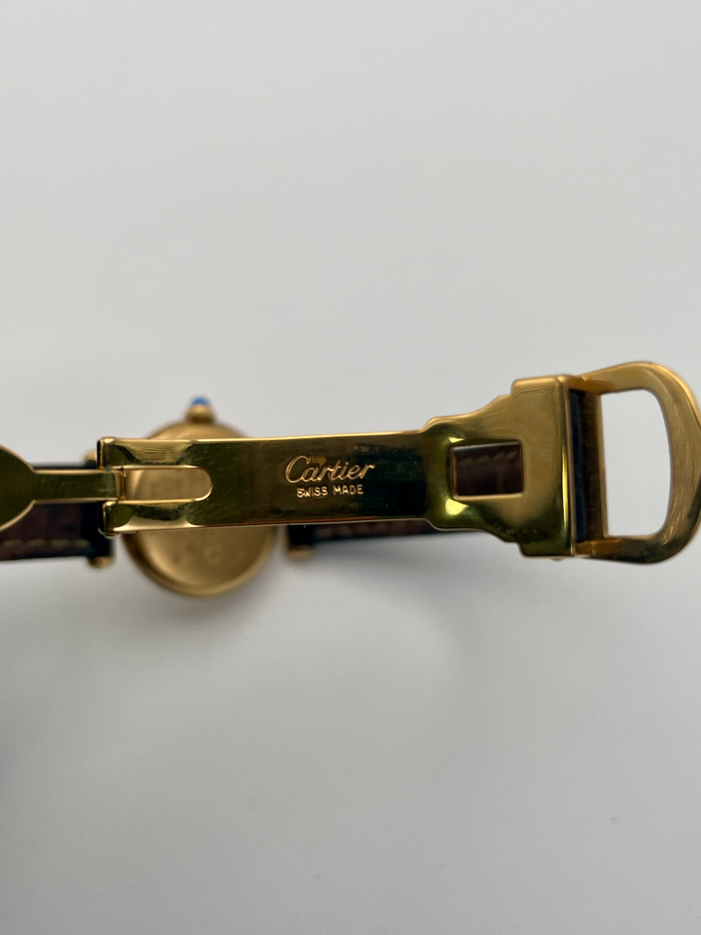 Clasp view of Cartier Colisée Vermeil watch with an engraved Cartier logo on the gold-tone buckle.