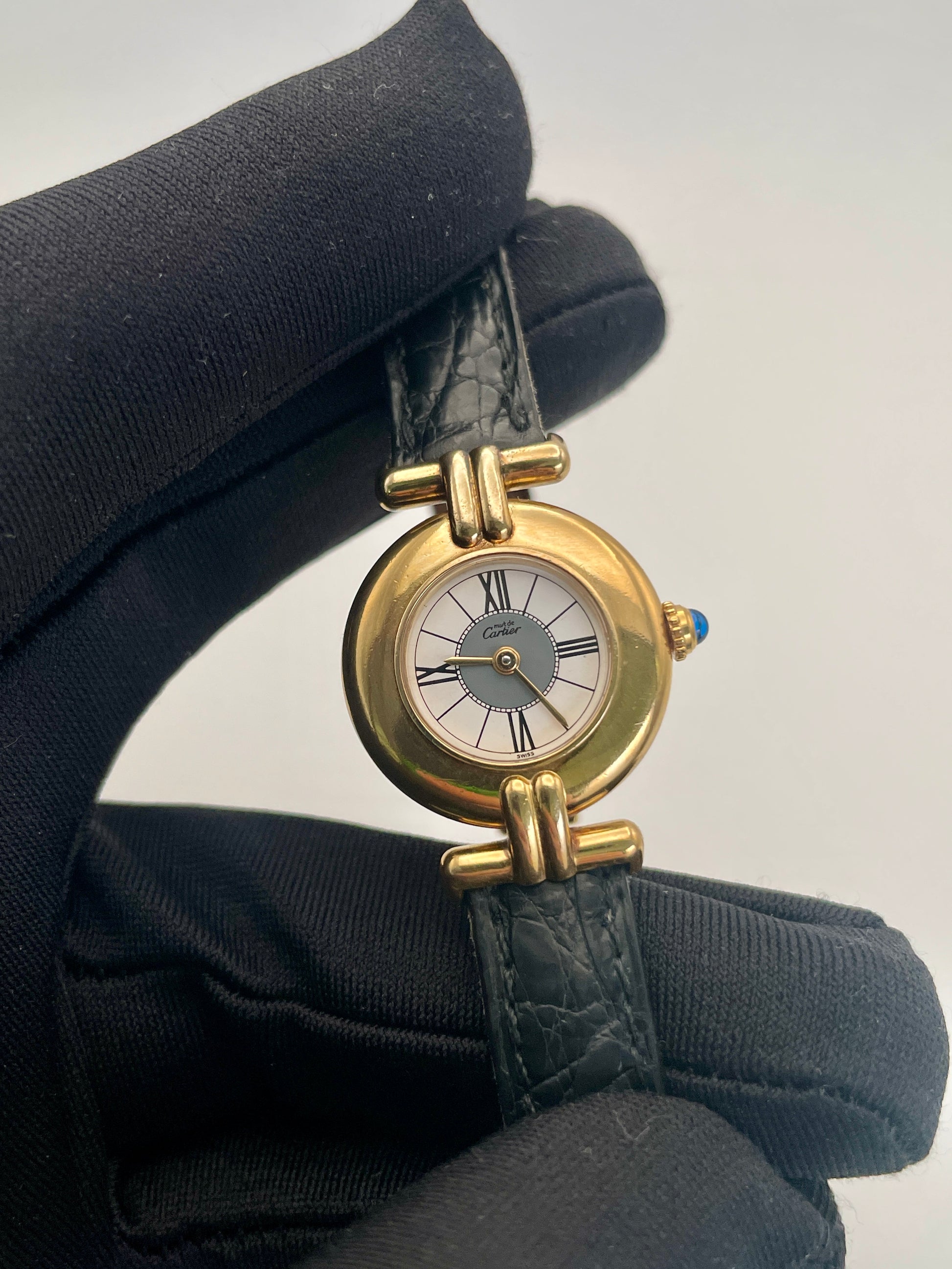 Close-up view of Cartier Colisée Vermeil watch showing detailed craftsmanship of the gold-tone case and Roman numeral dial.
