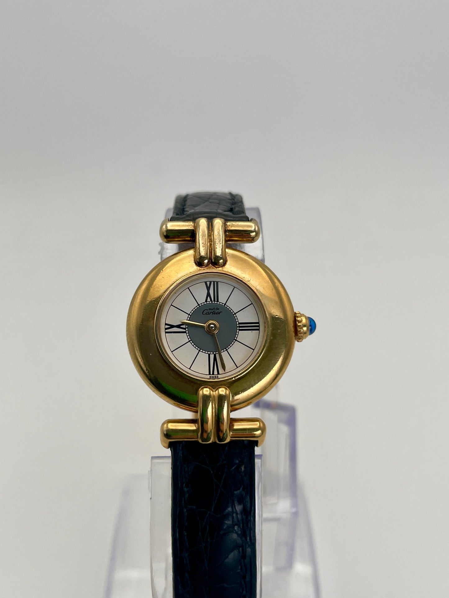 Front view of Cartier Colisée Vermeil watch featuring a gold-tone round case, Roman numeral dial, and black leather strap.