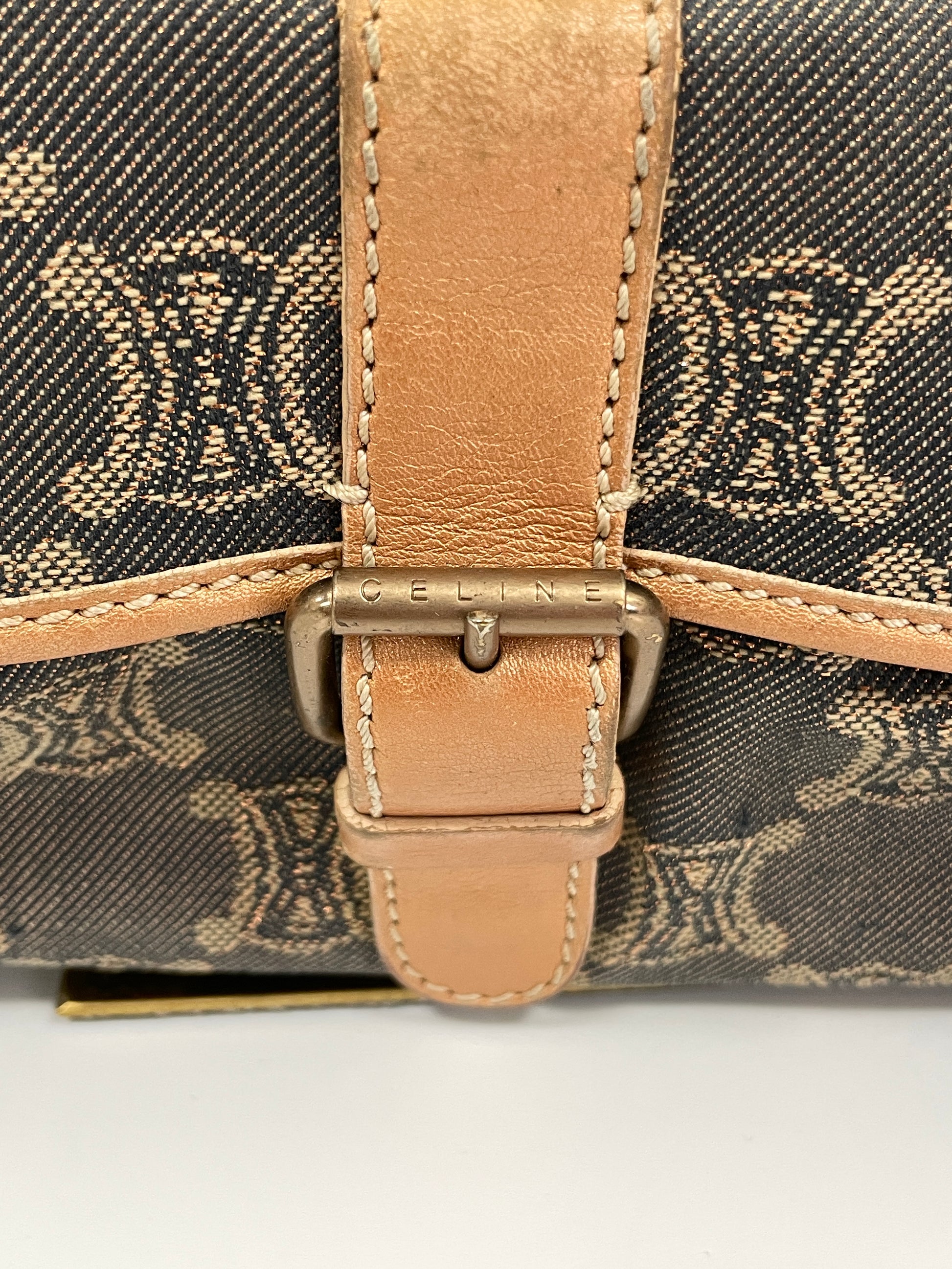 Close-up of the handle buckle detail on the Celine Macadam Shoulder Bag in denim, featuring the Celine logo on the buckle.