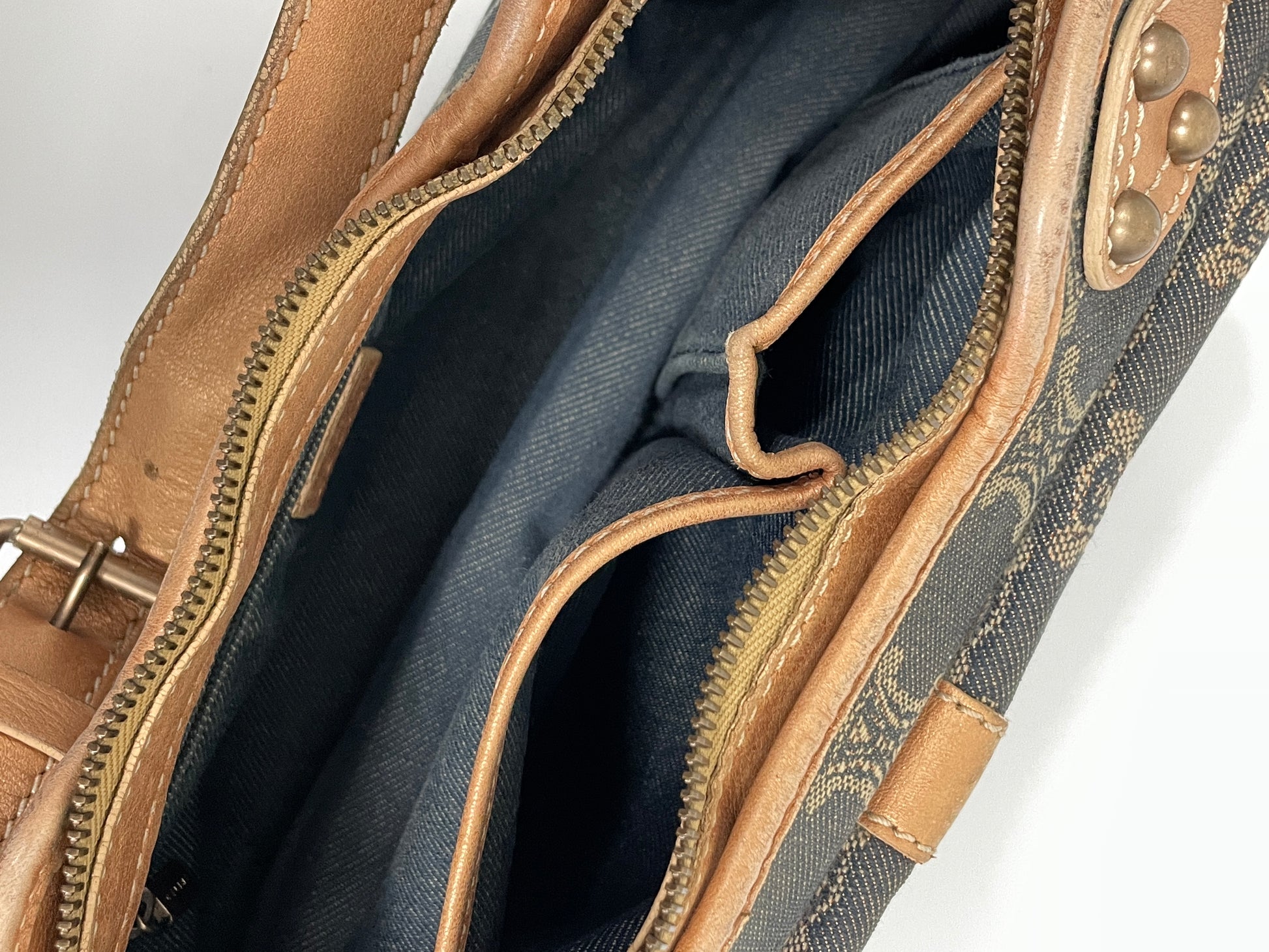 Interior view of the Celine Macadam Shoulder Bag in denim, showing the spacious compartment and zipper pocket.