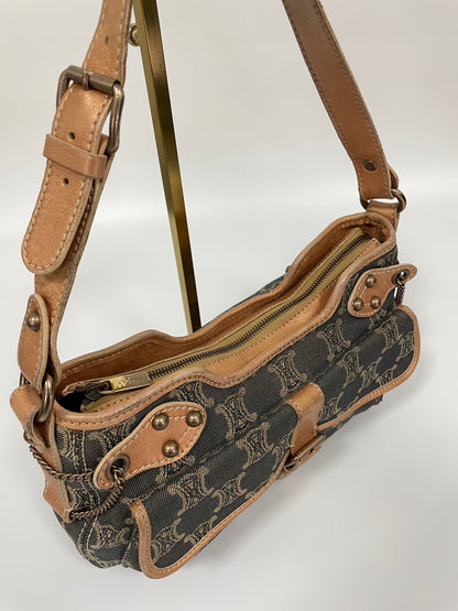 Top handle view of a Celine Macadam Shoulder Bag in denim, showing adjustable tan leather straps and zipper closure.