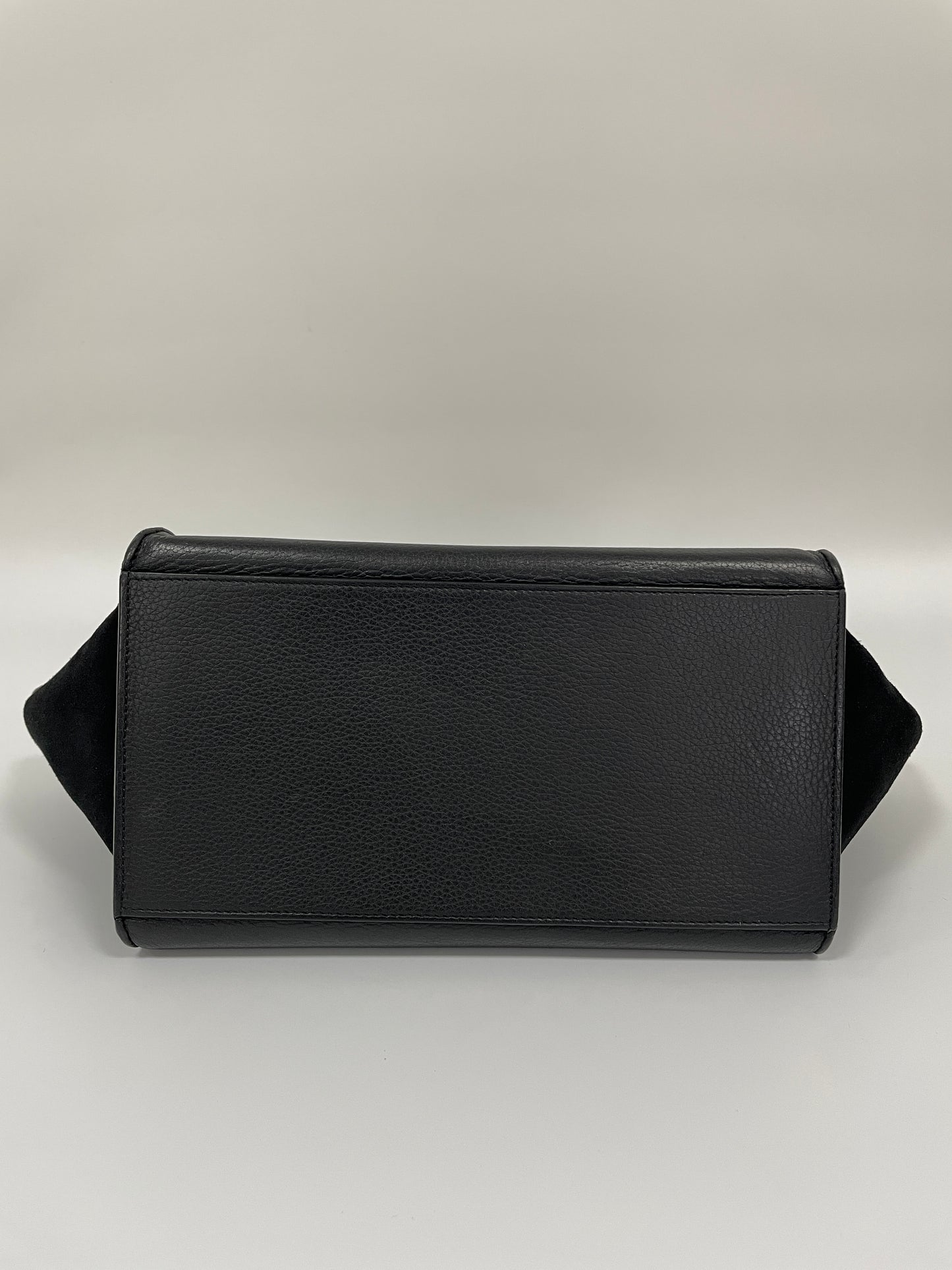 Bottom view of the Celine Trapeze Bag in black leather and velvet trim, showcasing its structured base.