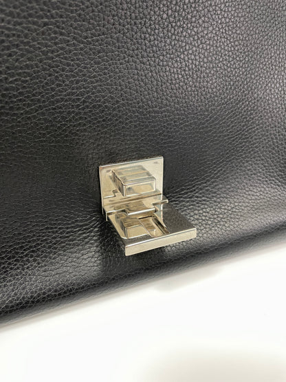 Close-up of the Celine Trapeze Bag's silver-tone clasp on the black leather flap.