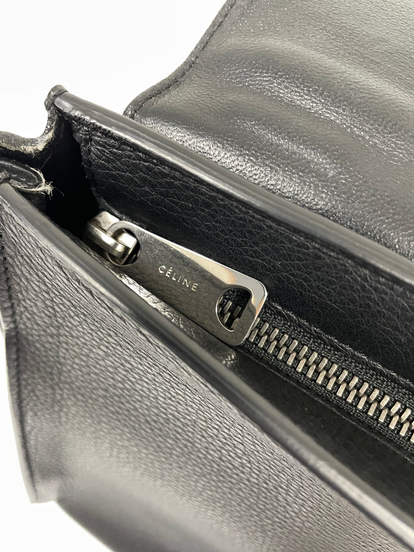 Close-up of the Celine hardware on the black leather Celine Trapeze bag with velvet side panels.