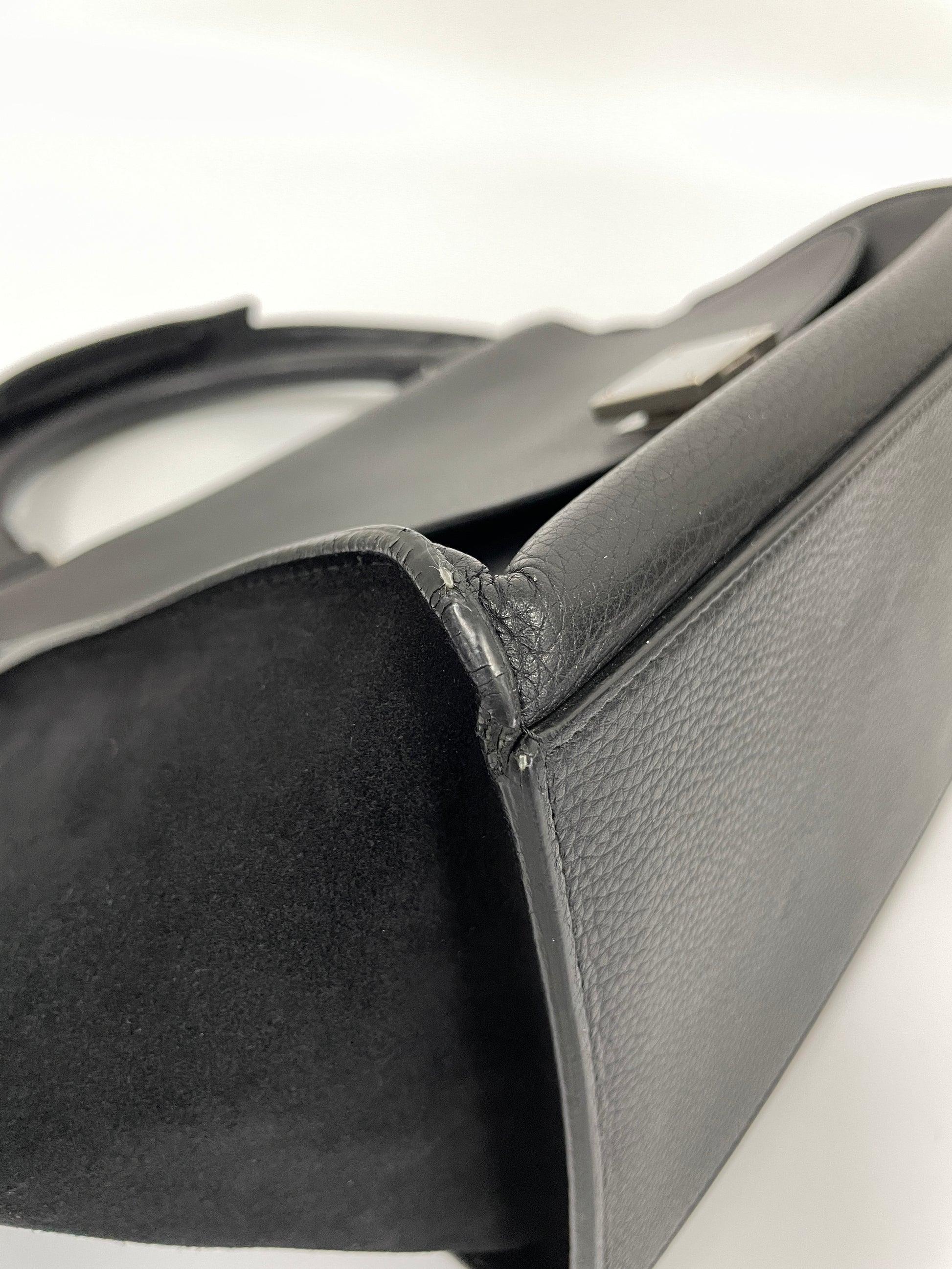 Close-up of a corner of the Celine Trapeze Bag in black leather and velvet trim, showing no wear on the leather.