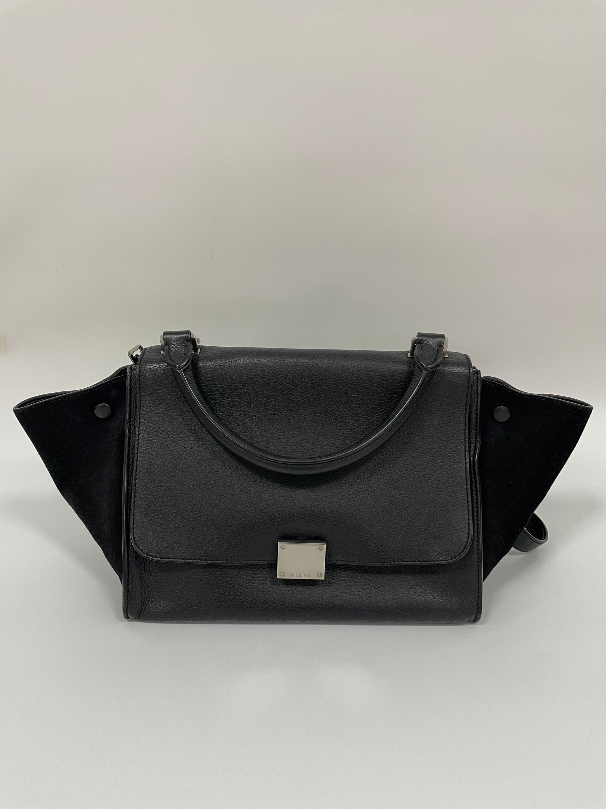 Celine Trapeze Bag in black leather with velvet trim, featuring a front flap and a silver-tone clasp, main front view.