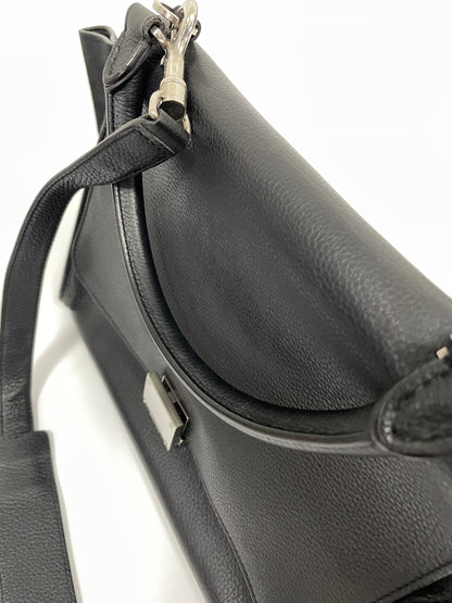 Detailed view of the Celine Trapeze Bag's top handle in black leather, with metal attachments.