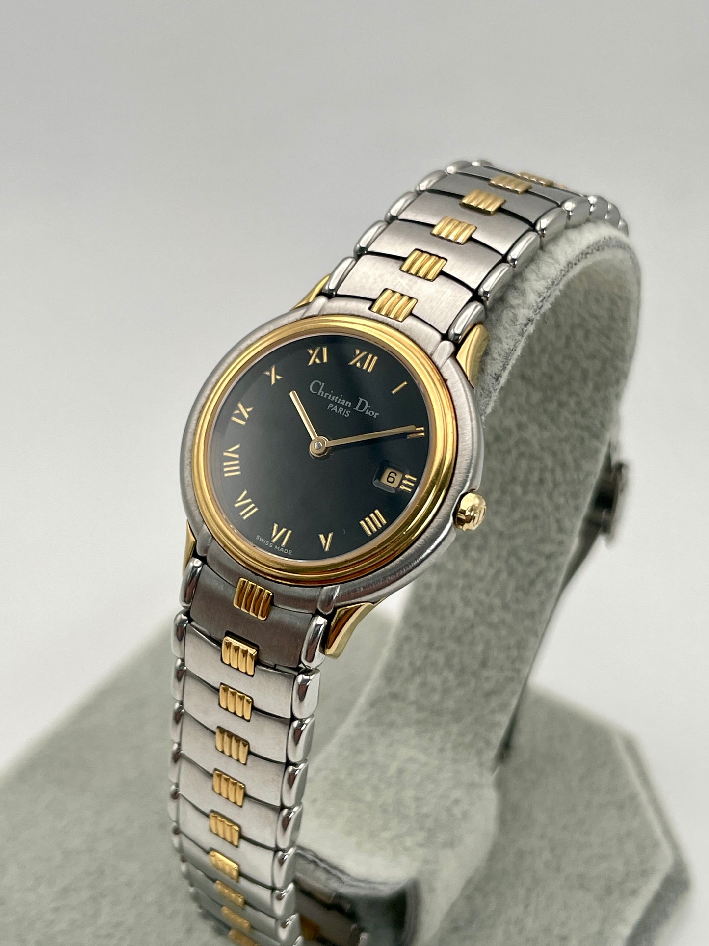 Diagonal view of the Christian Dior 48.146 vintage watch highlighting the black dial and gold-tone Roman numerals.