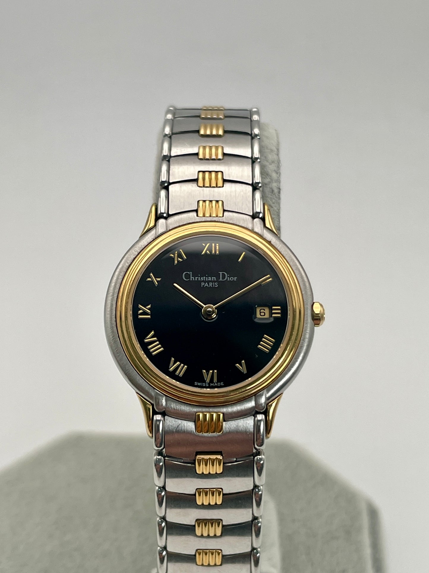 Close up front view of Christian Dior 48.146 vintage women's watch with black dial and two-tone bracelet.