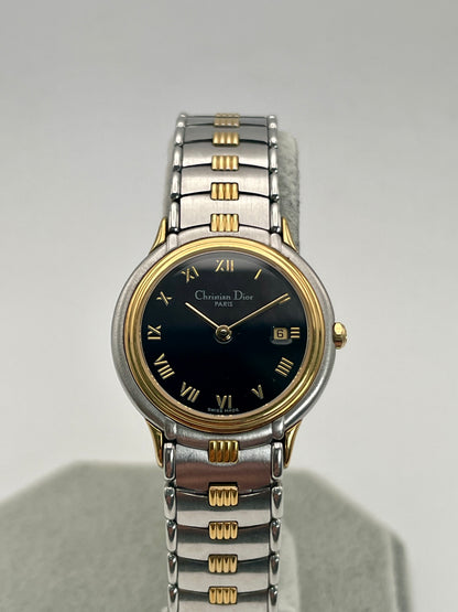 Close up front view of Christian Dior 48.146 vintage women's watch with black dial and two-tone bracelet.