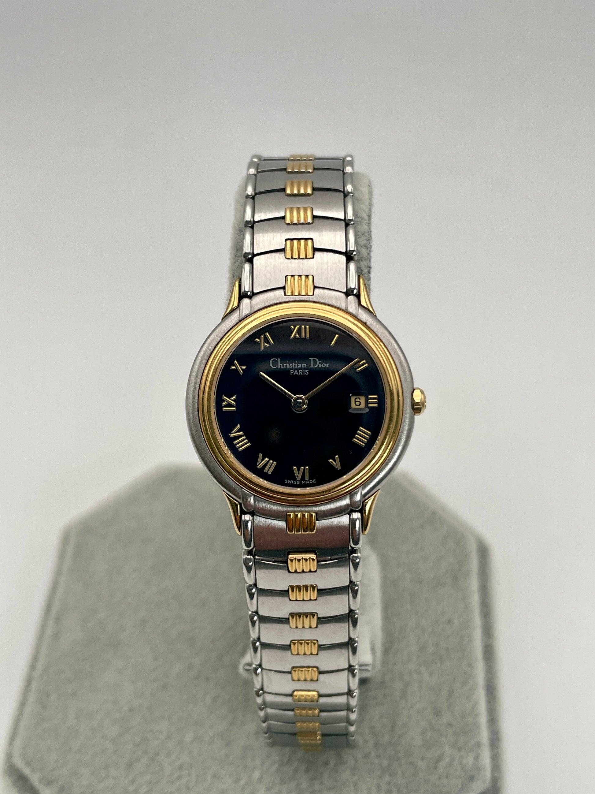 Front view of Christian Dior 48.146 vintage women's watch with black dial and two-tone bracelet.