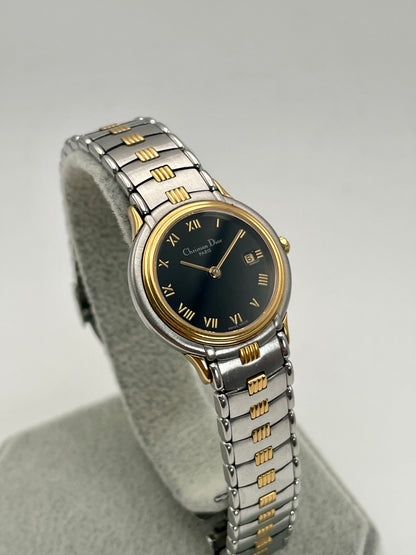 Front view of Christian Dior 48.146 vintage women's watch with black dial and two-tone bracelet.