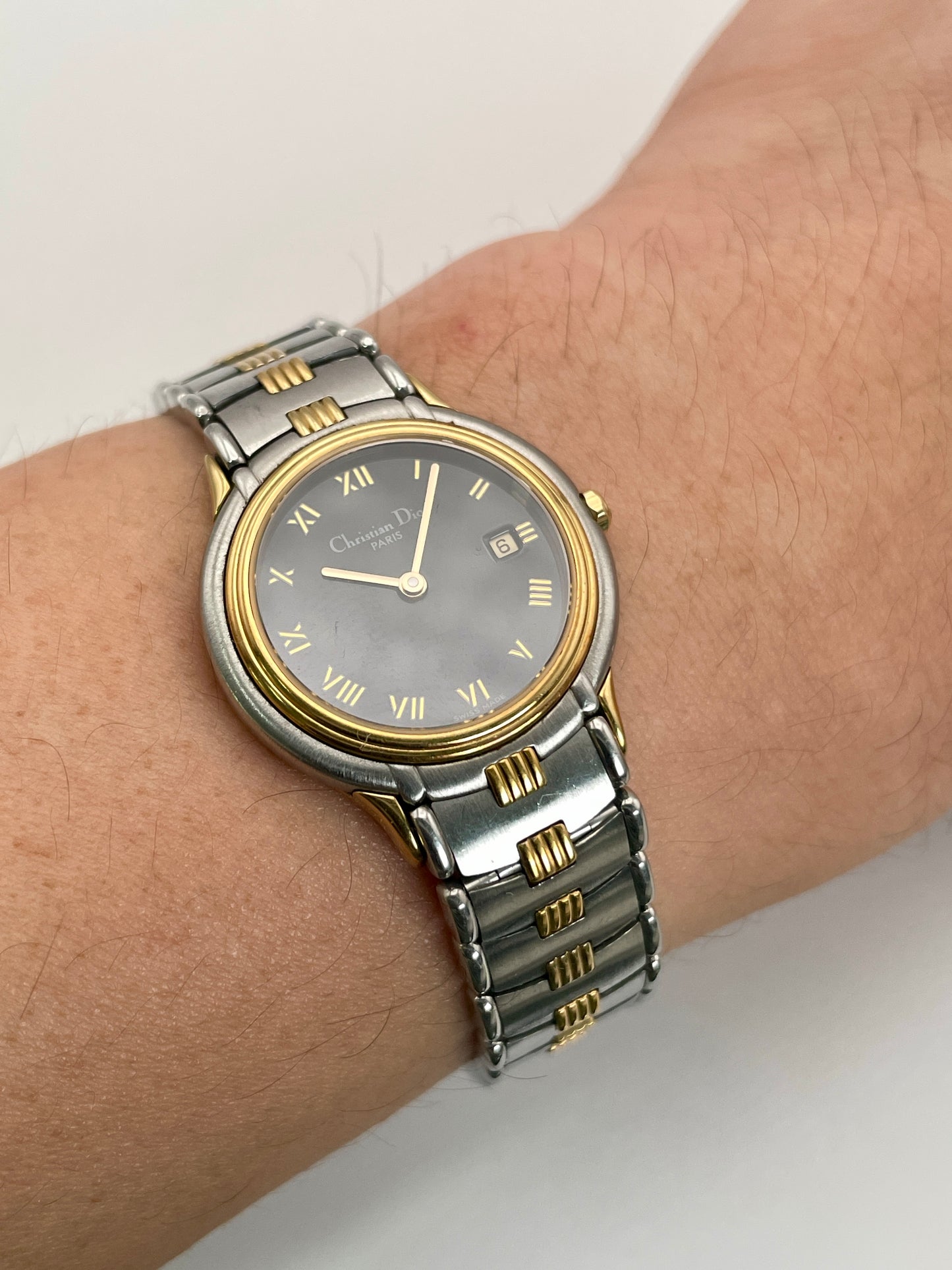 Christian Dior 48.146 watch worn on wrist, showcasing its sleek two-tone bracelet and refined dial.