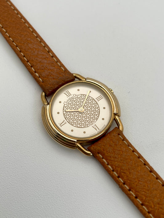 Christian Dior 58.121 vintage ladies watch in gold with brown leather strap, front view of dial with CD pattern.