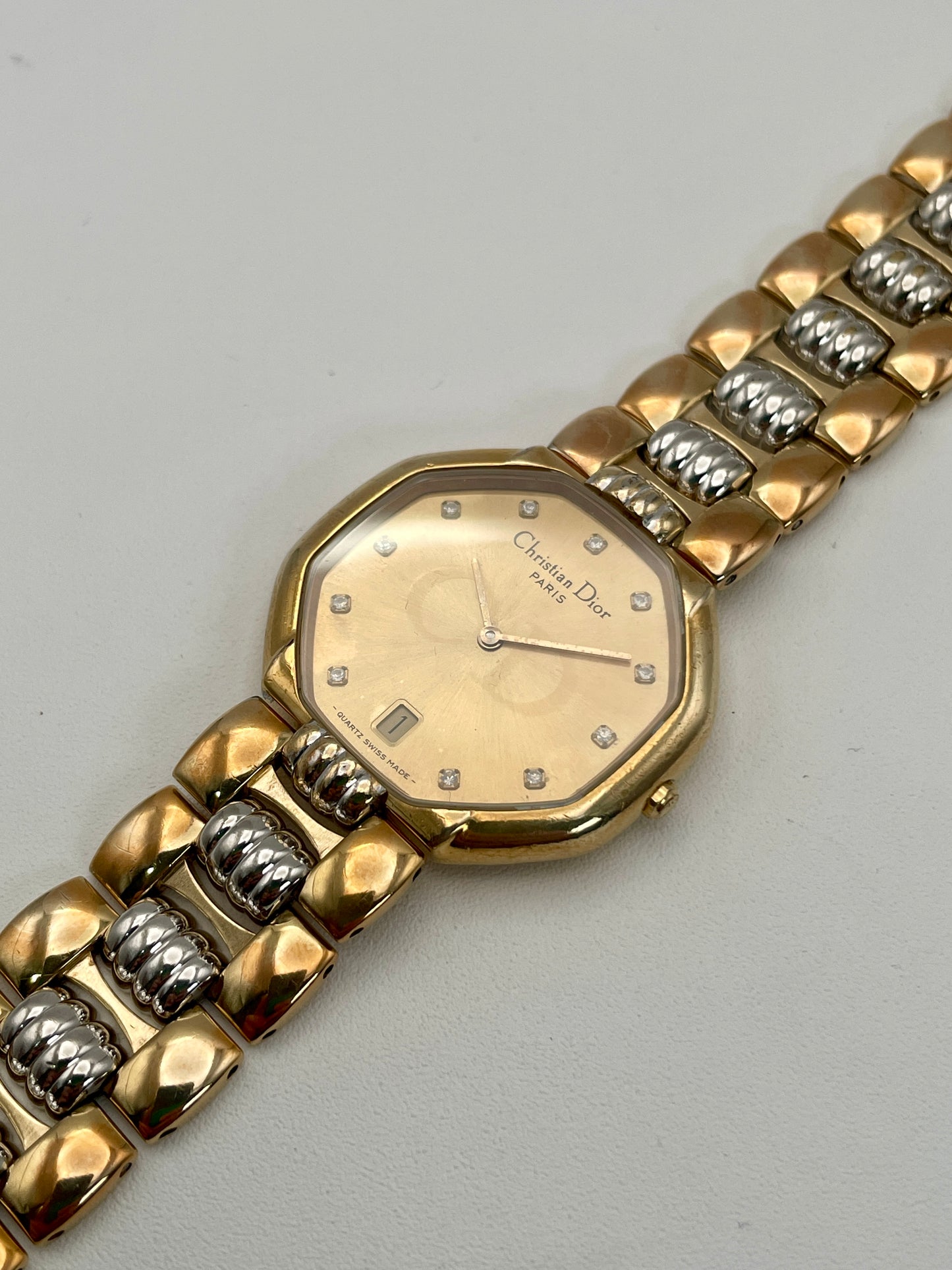 Angled view of the Christian Dior Depose vintage watch in two-tone gold and steel, showing the octagonal case and detailed bracelet links.