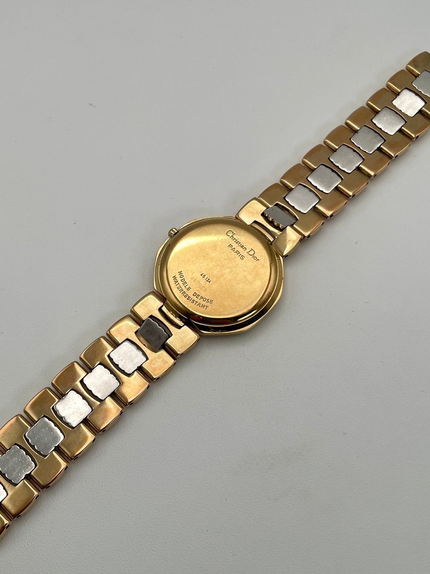 Close-up of the bracelet on the Christian Dior Depose vintage watch, featuring alternating gold and steel links with textured detailing.