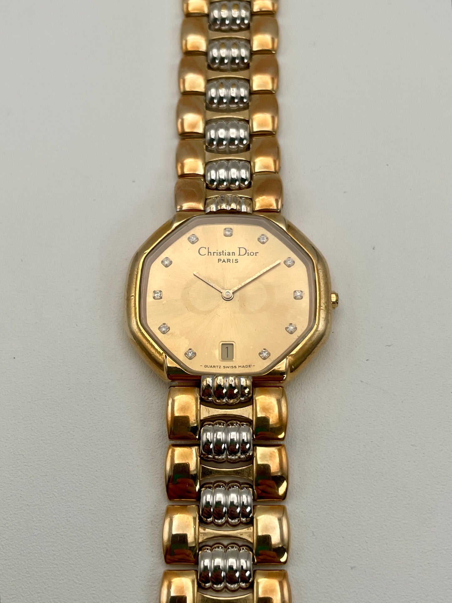 Front view of Christian Dior Depose vintage women's watch in two-tone gold and steel, showing octagonal dial with diamond-like markers and date window at 6 o'clock.