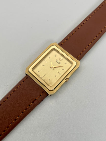 Angled view of Citizen Tank Vintage Watch highlighting its gold-tone case and brown strap.