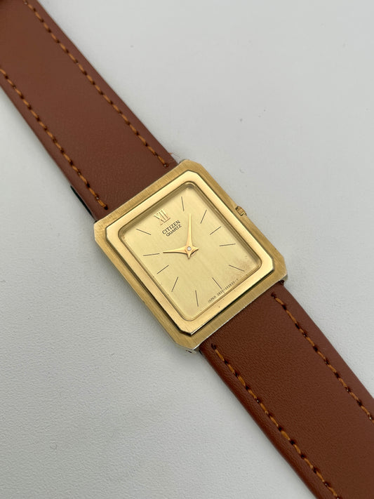 Close-up of the gold dial on Citizen Tank Vintage Watch featuring minimalist design.