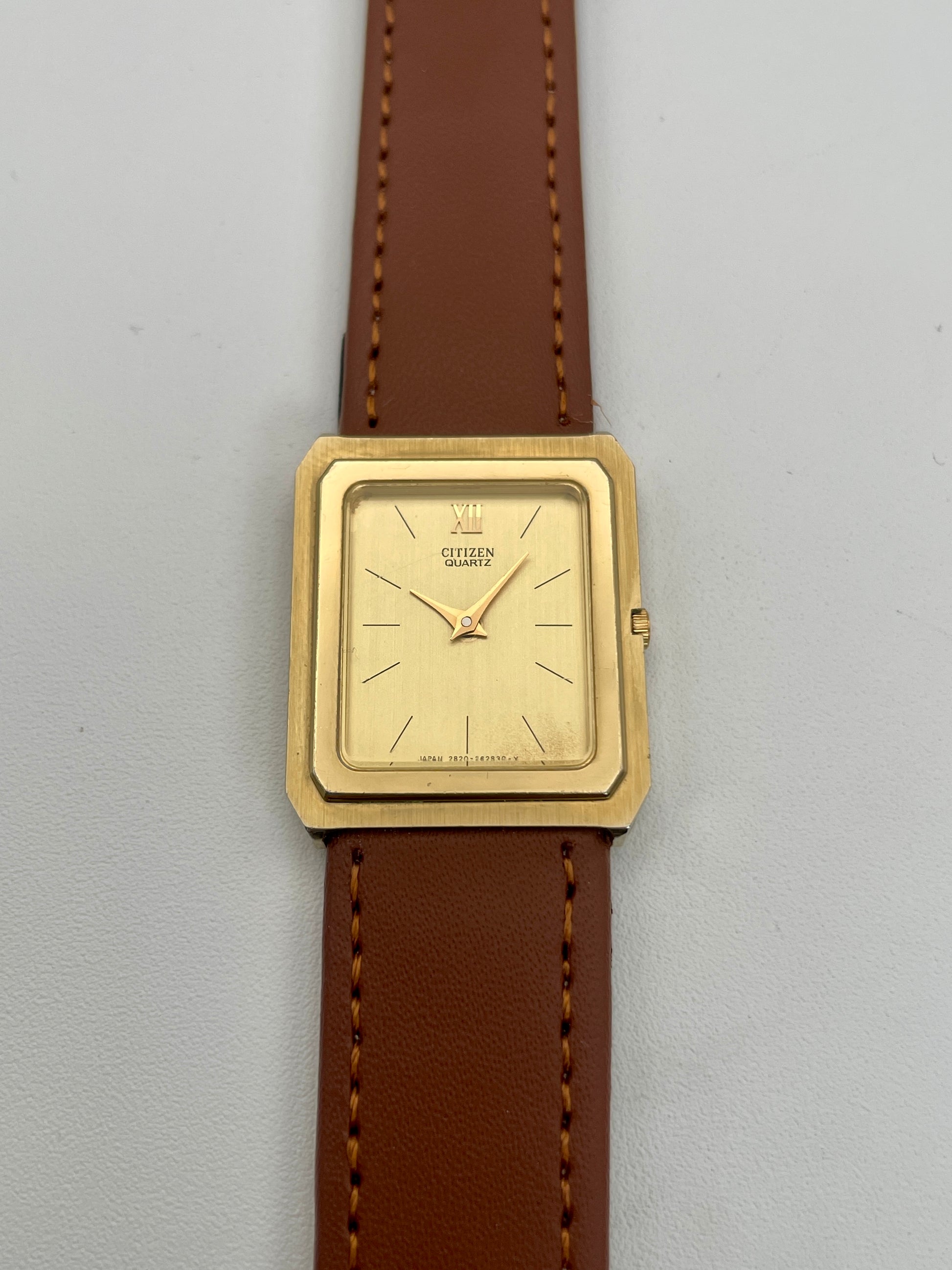 Front view of Citizen Tank Vintage Watch in gold with brown leather strap.