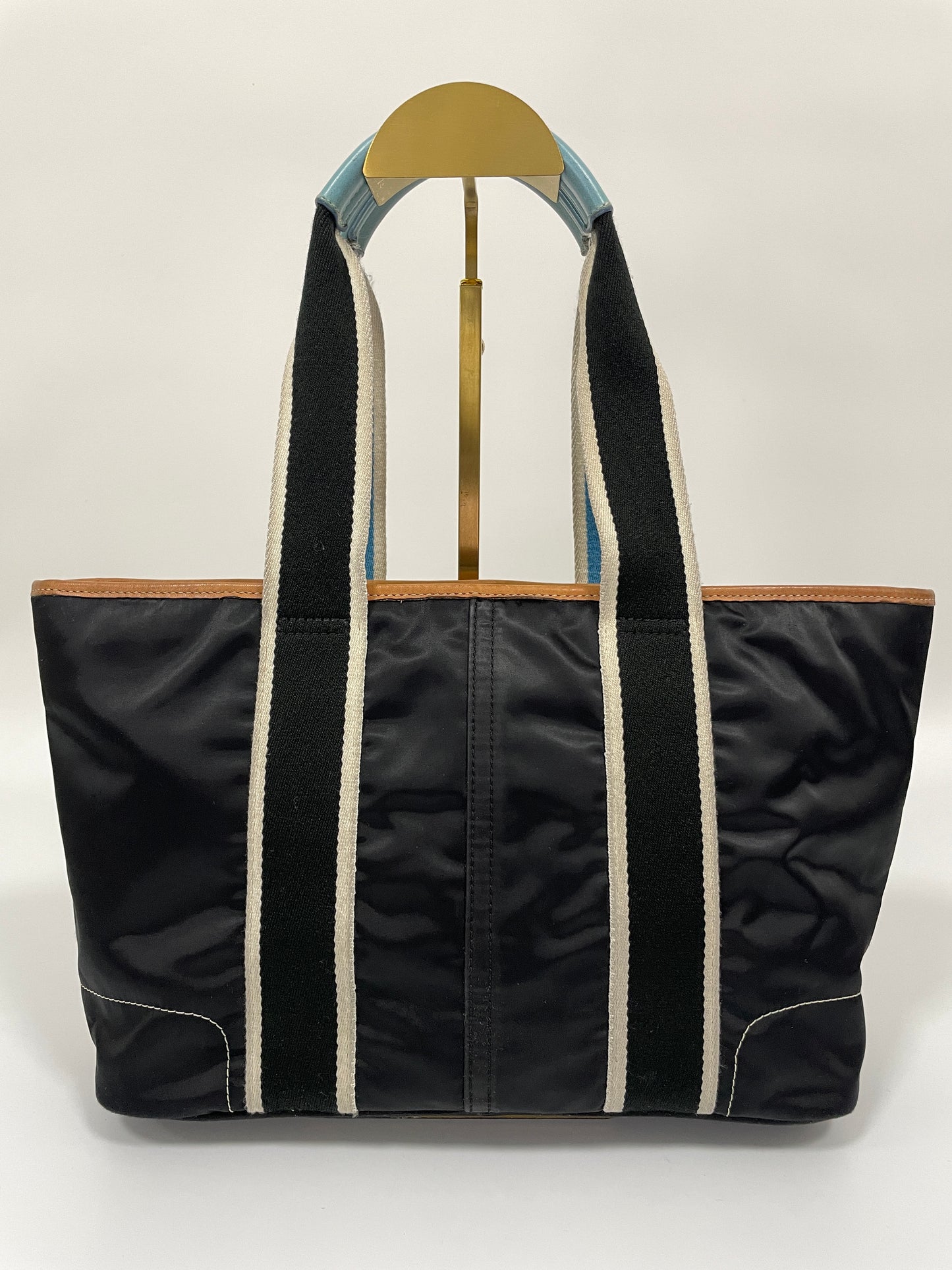 Back view of the Coach Hampton tote bag in dark navy, highlighting the smooth nylon texture and stitching.