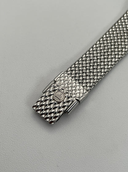 Close-up view of the clasp of Credor 2F70 bracelet watch, focusing on the silver-tone rectangular case, and the finely detailed mesh bracelet.