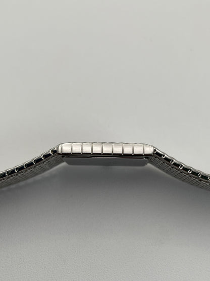 Side profile of a Credor 2F70 bracelet watch, focusing on the slim silver-tone case and the textured mesh bracelet design.