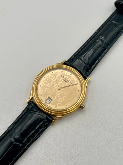 Christian Dior 45.122 vintage women's watch in gold case with gold CD dial and black strap, diagonal angle
