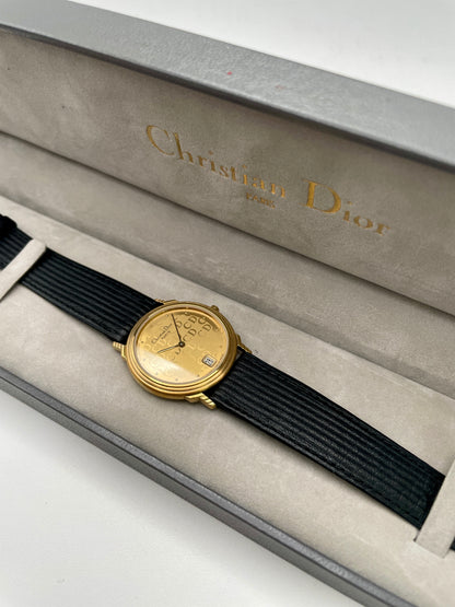 Christian Dior 45.122 vintage women's watch in gold with monogram dial and black ribbed strap, shown inside original Dior box
