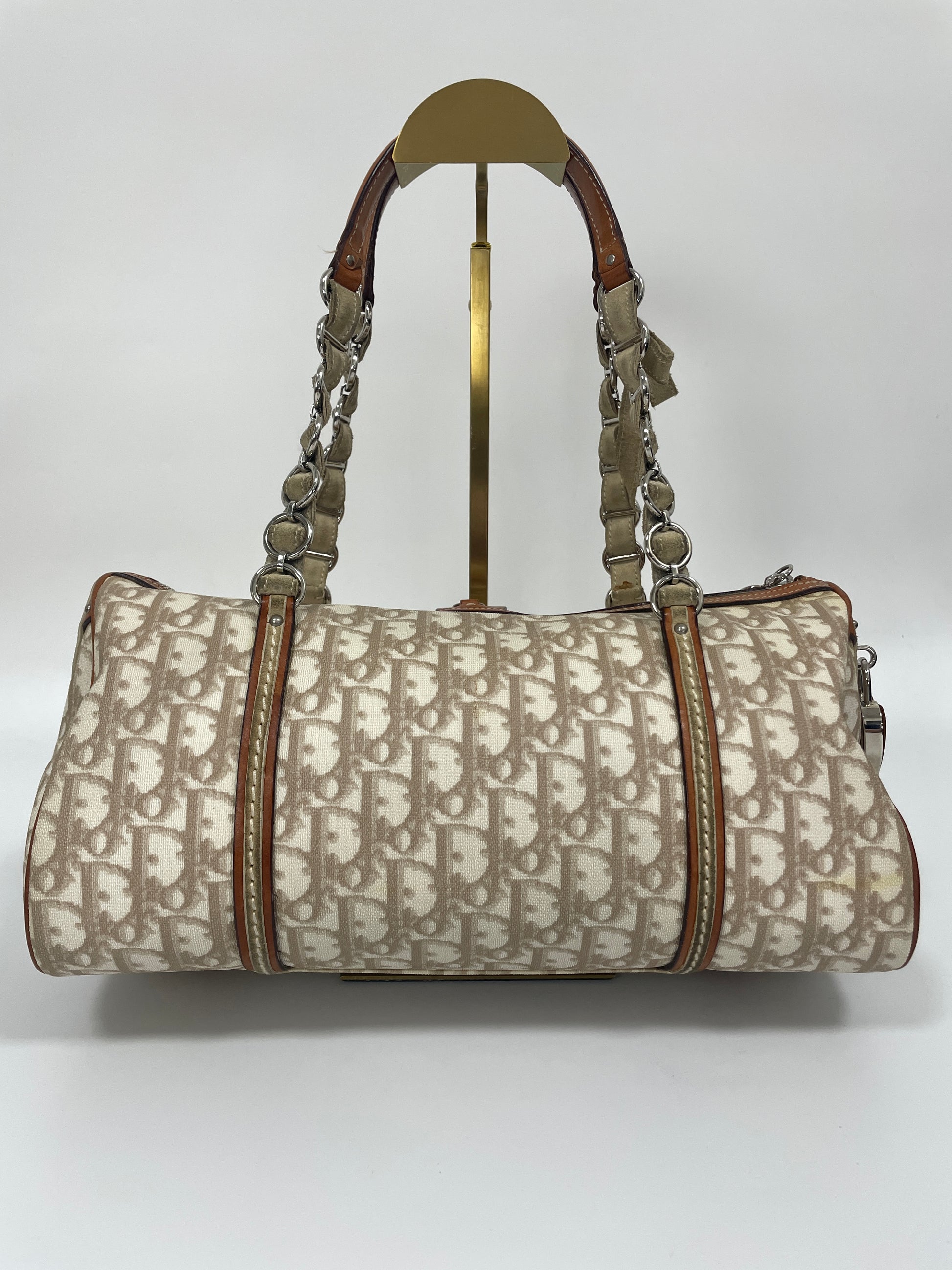 Back view of Christian Dior Trotter Romantique bag in beige leather and canvas with suede and leather details.