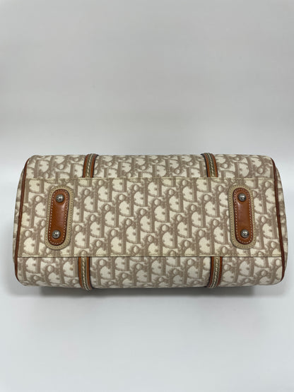 Bottom view of Christian Dior Trotter Romantique bag in beige leather and canvas with leather accents.