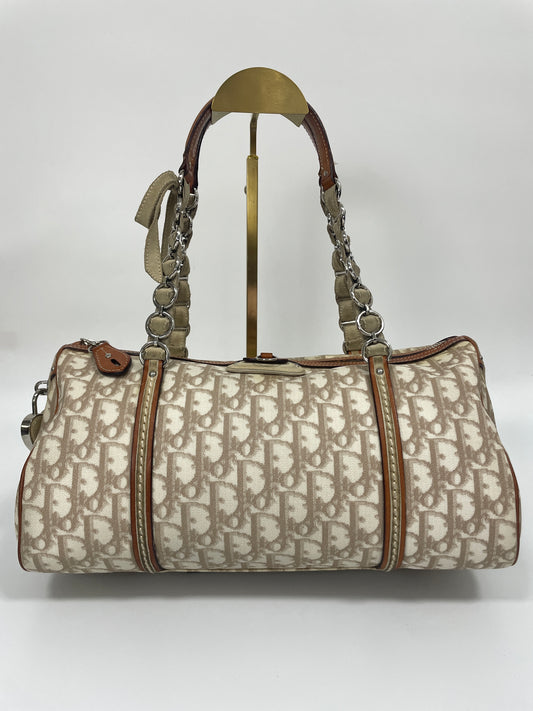 Front view of Christian Dior Trotter Romantique bag in beige leather and canvas with chain straps.