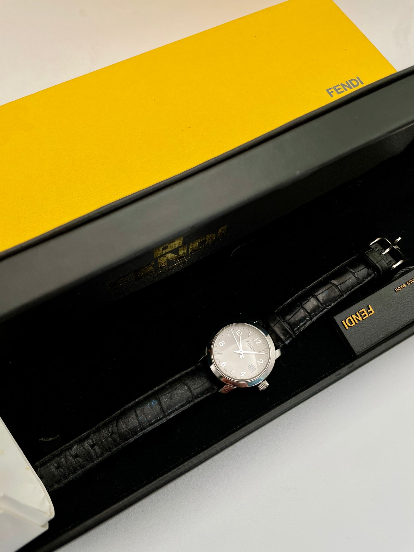 Fendi 2100L watch displayed with original yellow and black Fendi box