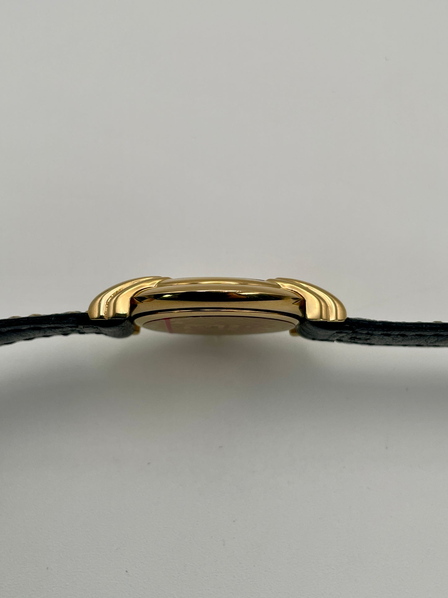 Side profile of the Fendi 300J showing the slim gold case and curved lugs.