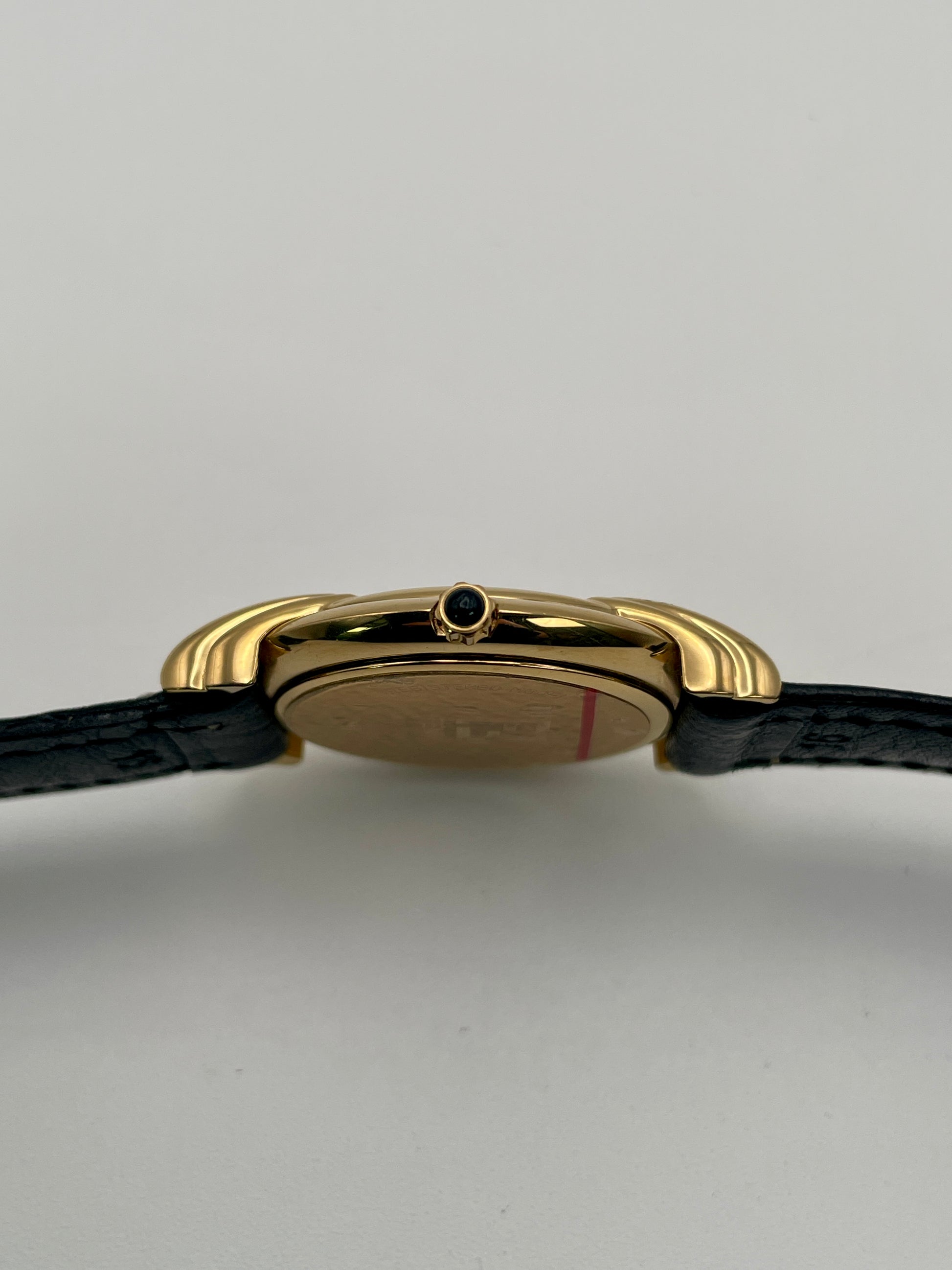 Close-up side view highlighting the small cabochon crown on the Fendi 300J gold case.