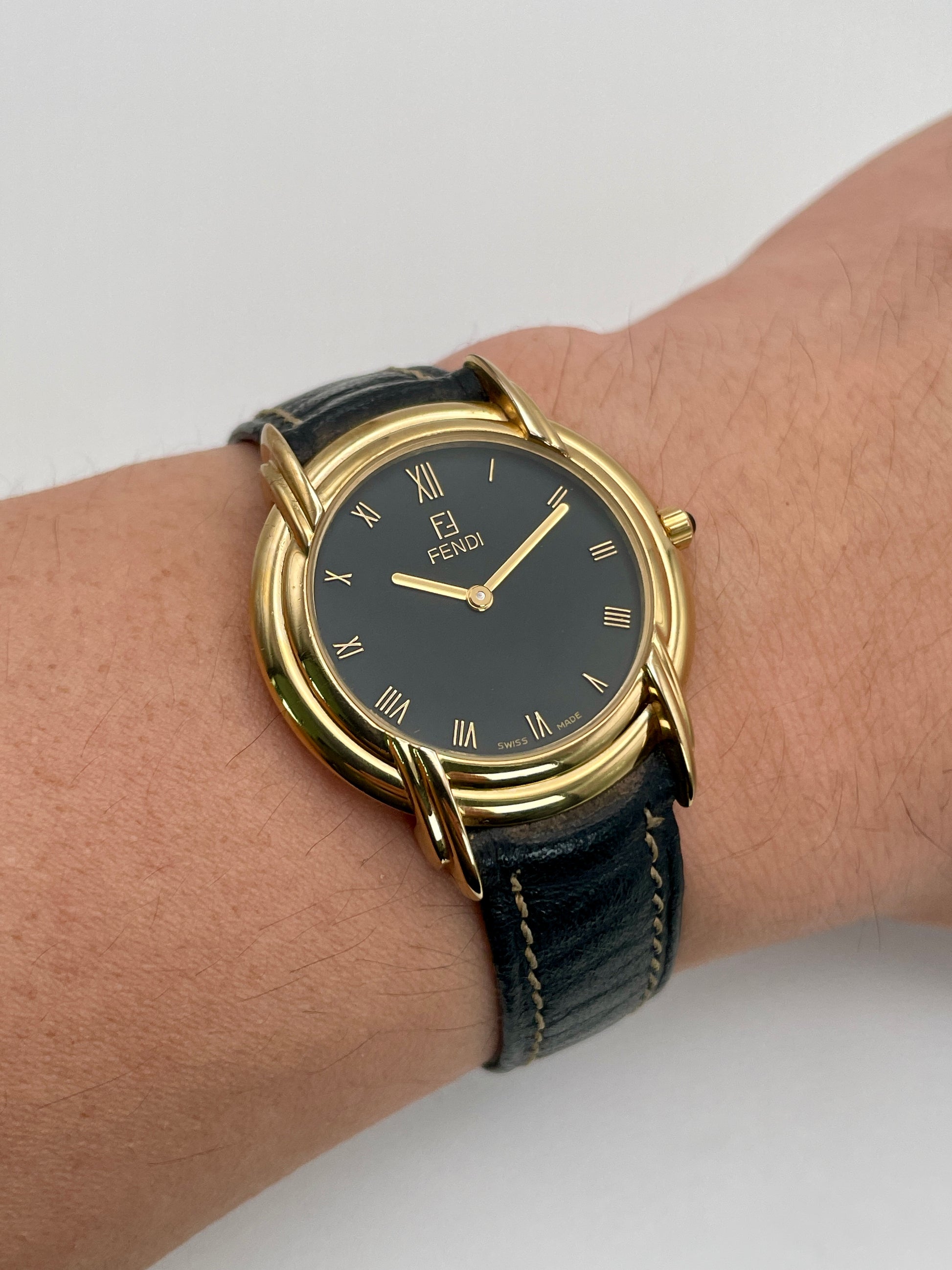 Wrist shot of the Fendi 300J gold vintage watch worn on the wrist, showing its classic size and elegant fit.