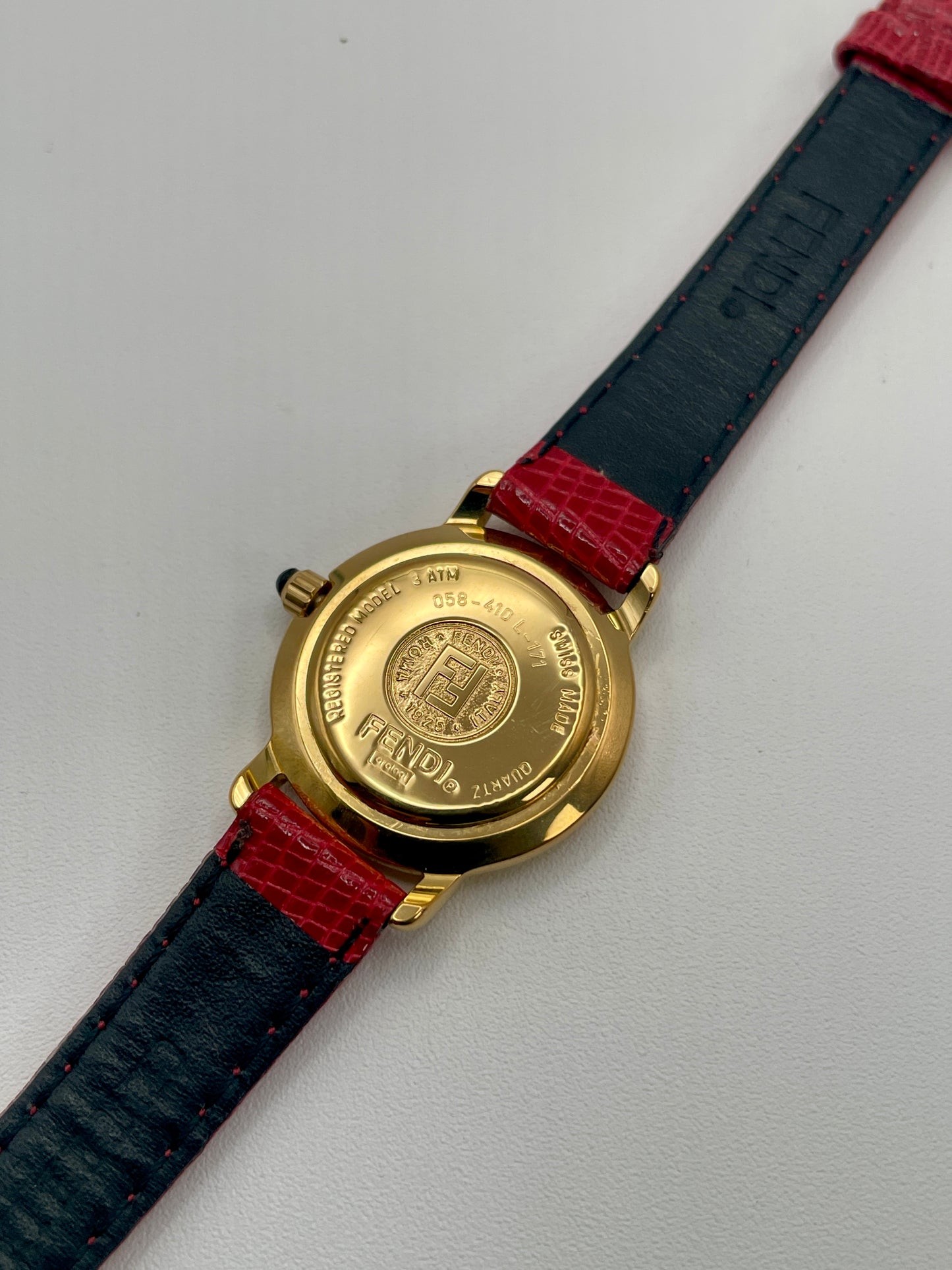 Caseback of the Fendi 410L watch showing engraved Fendi logo and model number on gold-tone back