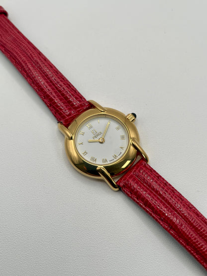 Front view of the Fendi 410L watch showing gold case, white Roman numeral dial, and red leather strap