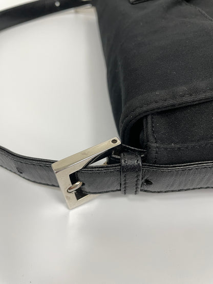 Detail of the black leather strap and buckle of the Fendi Baguette Bag in black neoprene.