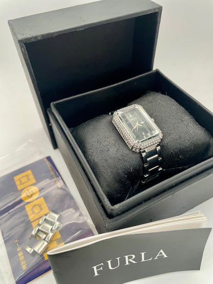 View of Furla Crystal Pave ladies' watch with a rectangular crystal-set case and a polished stainless steel bracelet in its box and showing inclusions and extra links.

