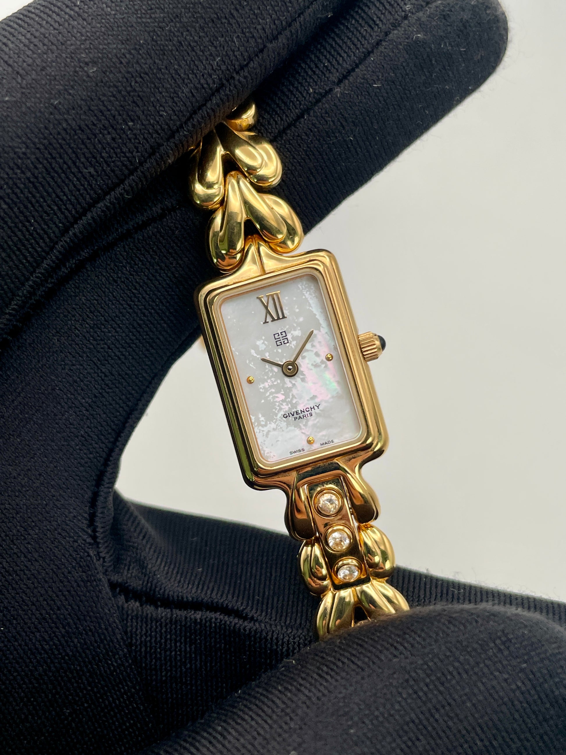 Close-up of the Givenchy Bambou watch showing dial details, crystal accents, and bracelet texture