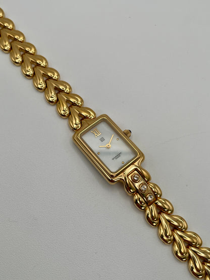 Flatlay of the Givenchy Bambou gold watch showing the full bracelet and dial facing up