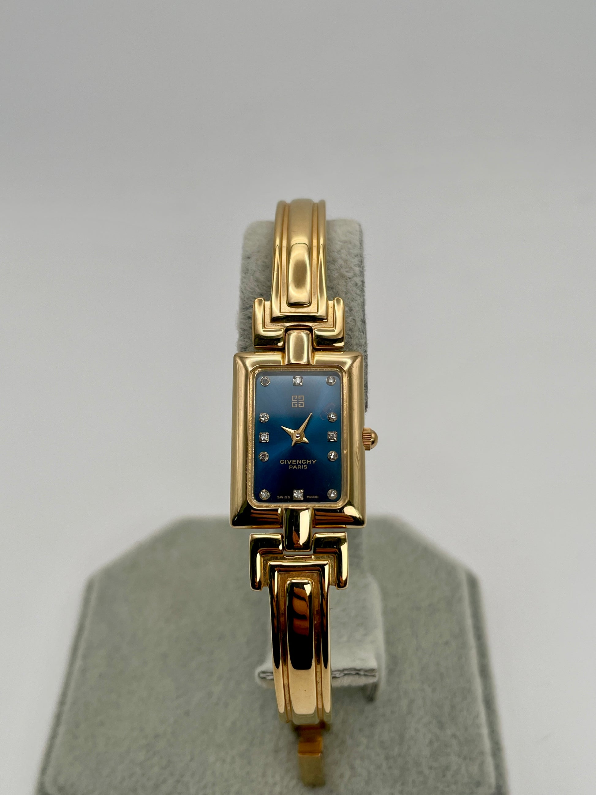 Front view of the Givenchy Millesime Vintage Women’s Watch showing the gold rectangular case and blue dial with crystal hour markers