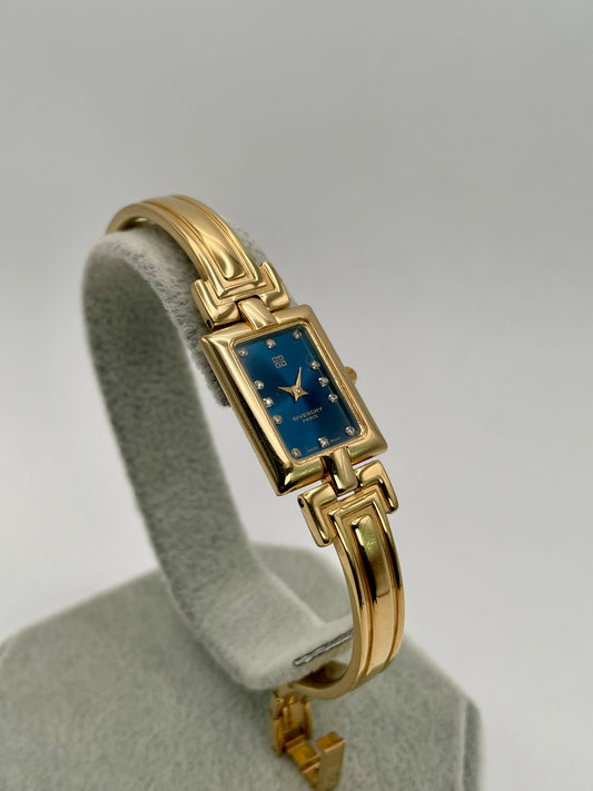 Main view of the Givenchy Millesime Vintage Women’s Watch showing the gold rectangular case and blue dial with crystal hour markers