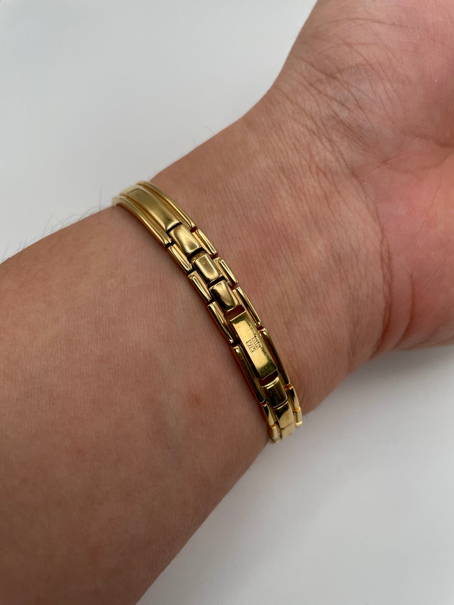 Rear wrist shot showing the gold bracelet and Givenchy clasp on the Millesime watch